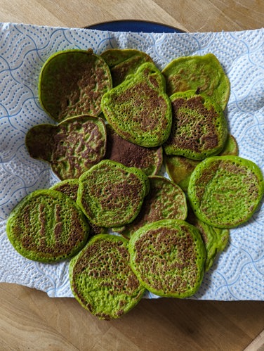 a small batch of spinach and sweetcorn fritters on kitchen roll